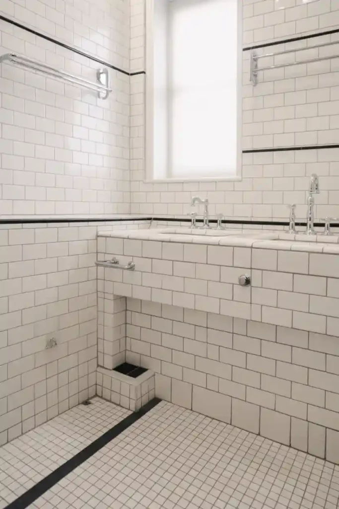 White Bathroom with Black Tile Inlays