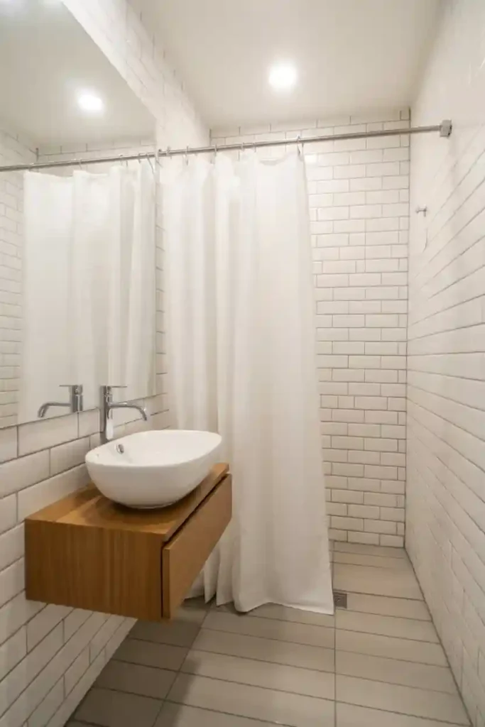Use Clear Shower Curtains or Glass Panels